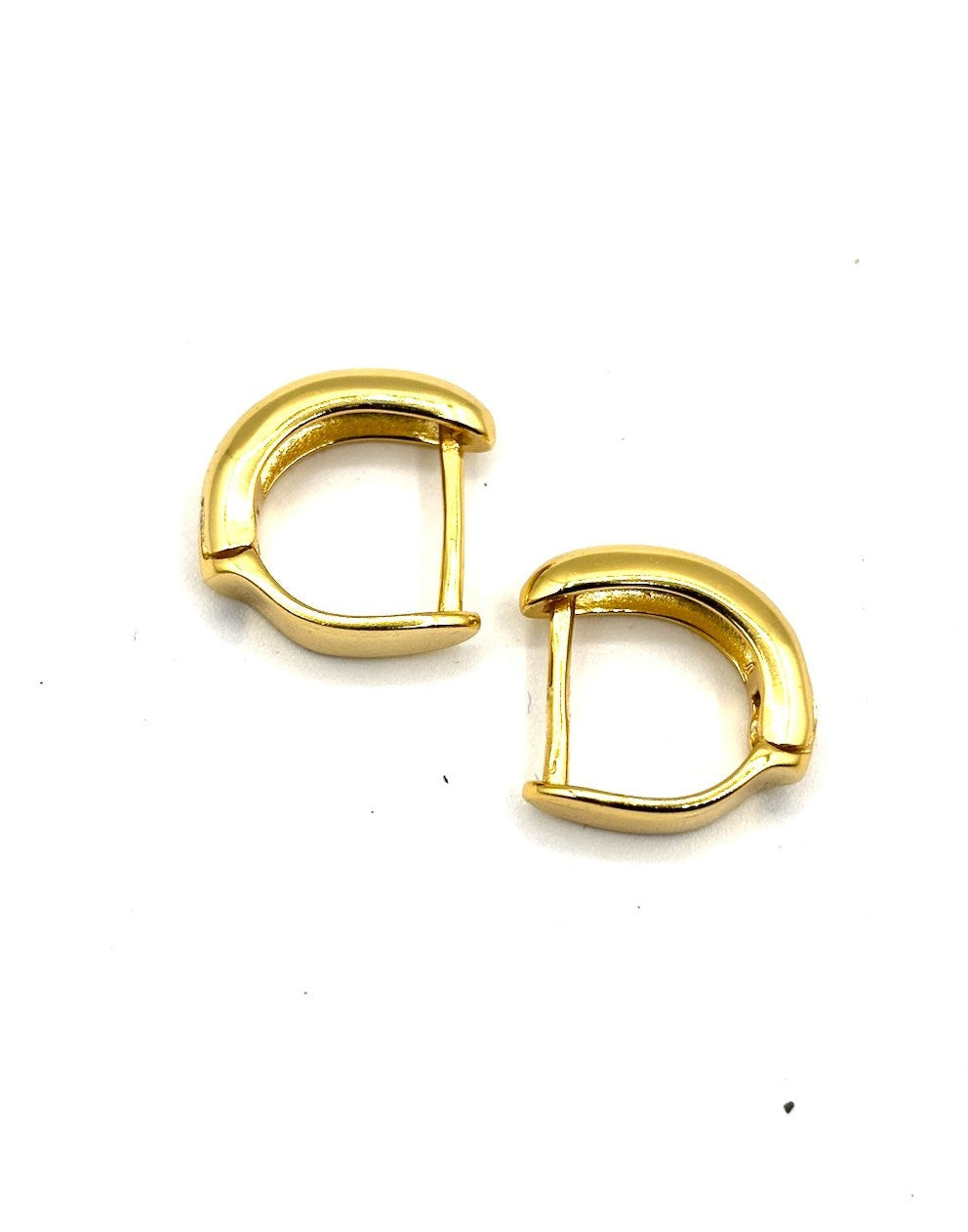 Gold hoop earrings on a white background